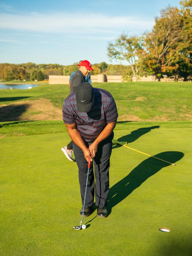 Chad Lumpkin over a putt on the green