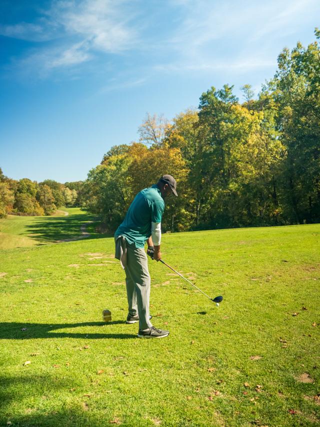 Claude driving off the tee